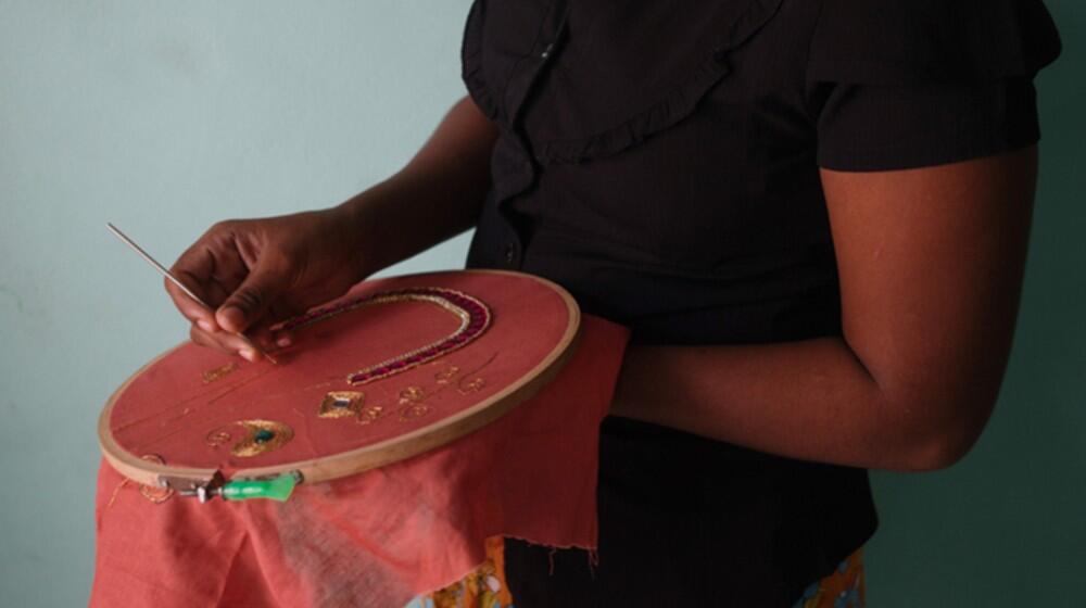 Woman sewing on clothe