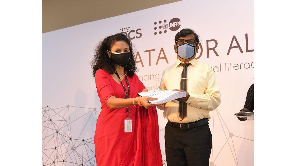 Ms. Sharika Cooray, Officer in Charge, UNFPA hands over a Sinhala Braille publication to Mr. Kamalsiri Nanayakkara, President of the Sri Lanka Council for the Blind