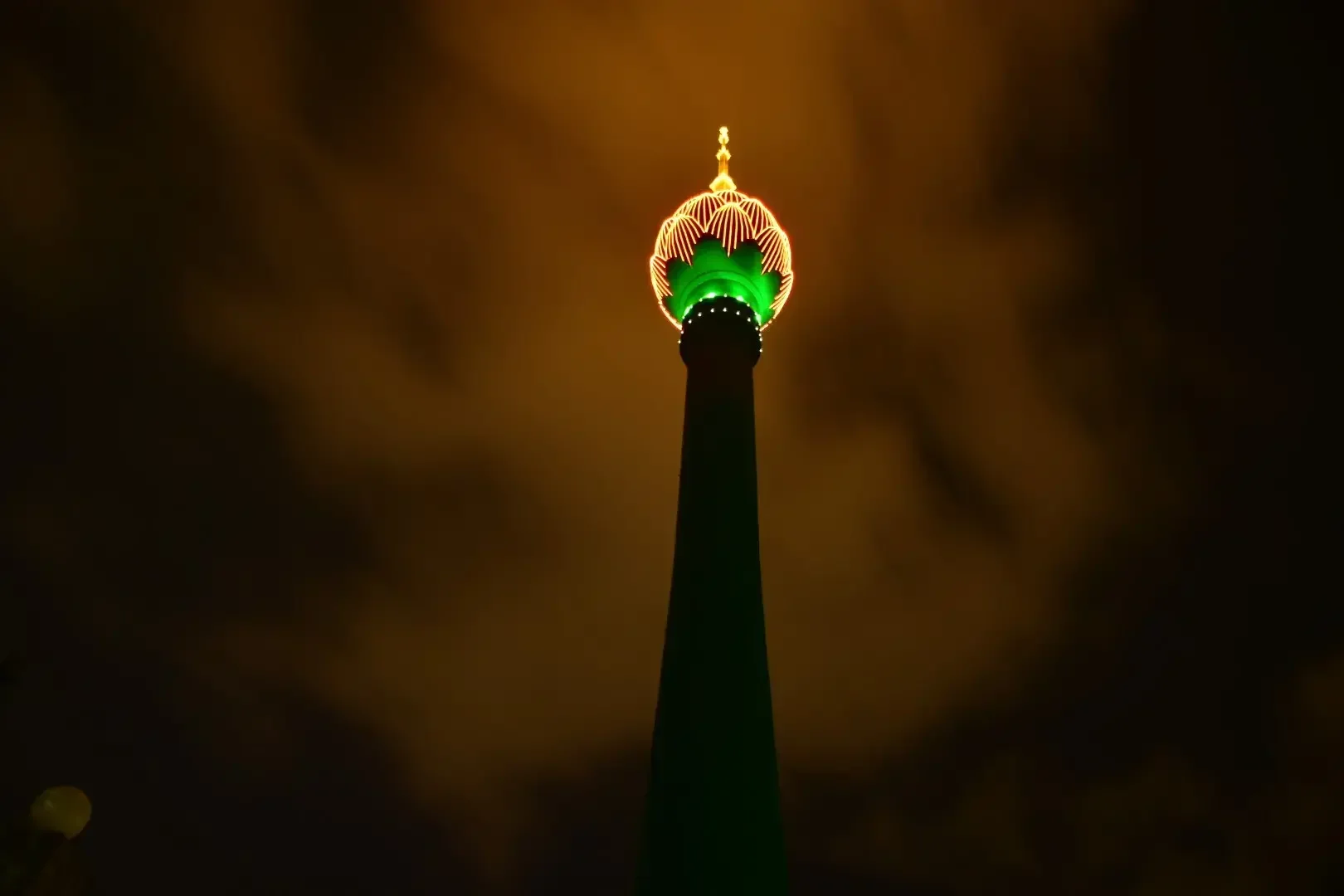 The Lotus Tower shines bright in orange to shed light on the shadow pandemic
